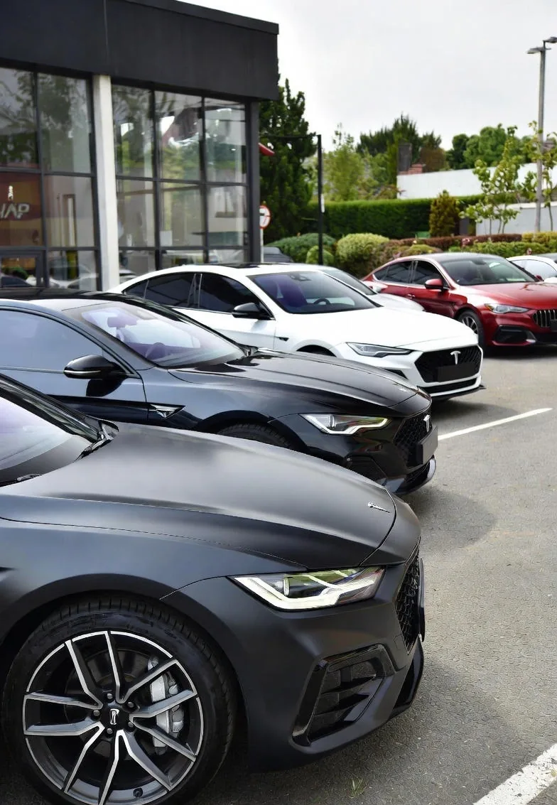 Luxury vehicles with matte wraps parked at Wrap Senators facility in Ottawa
