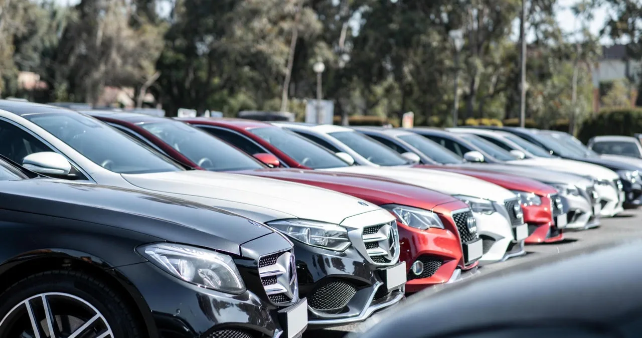 Row of luxury sedans and SUVs at a premium dealership in Ottawa